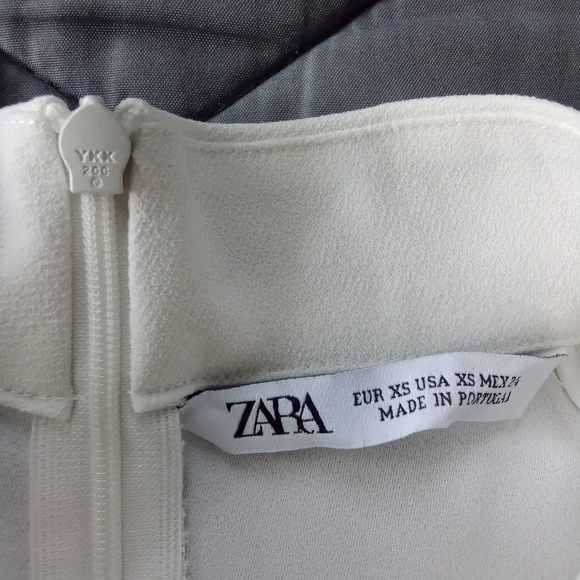 Women's Zara Sleeveless Mock Neck Split High Low Hem Zipper Back White Blouse - Picture 12 of 12